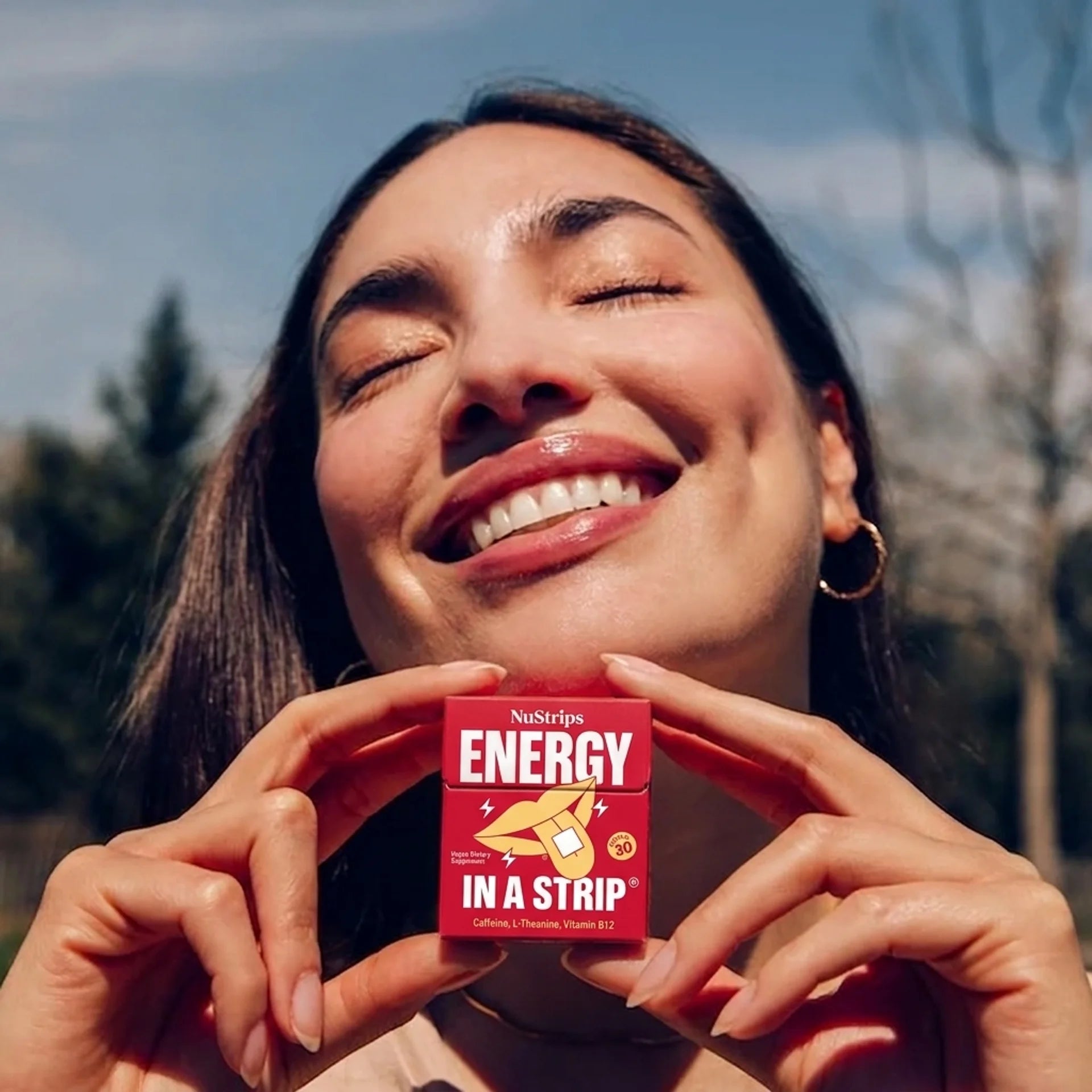 Woman holding NuStrips Energy