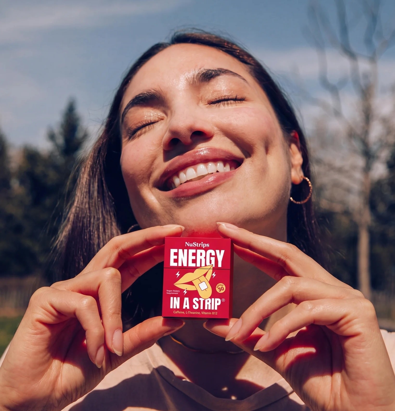 Woman holding NuStrips Energy